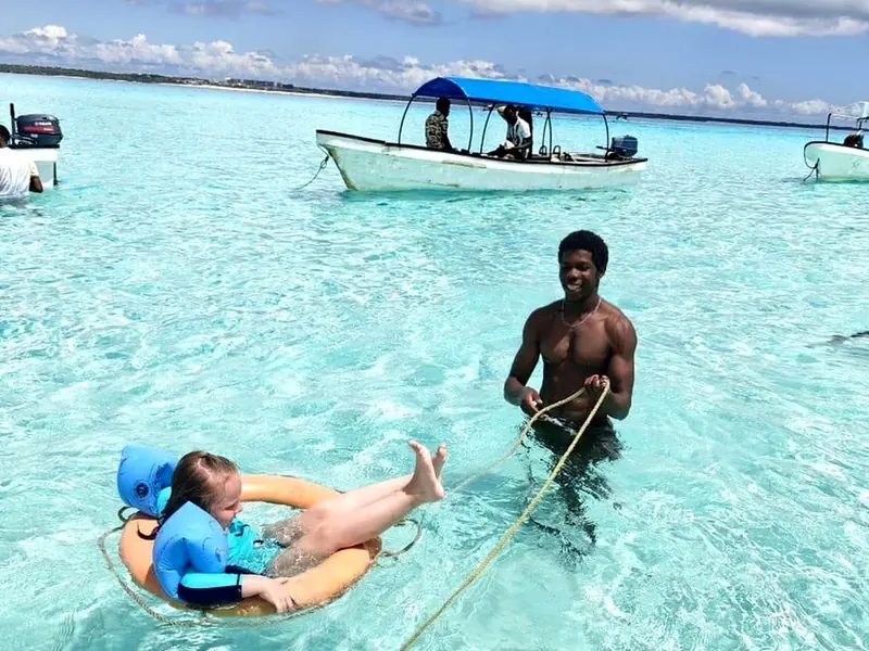 Guests swimming in turquoise water at a Zanzibar sandbank
